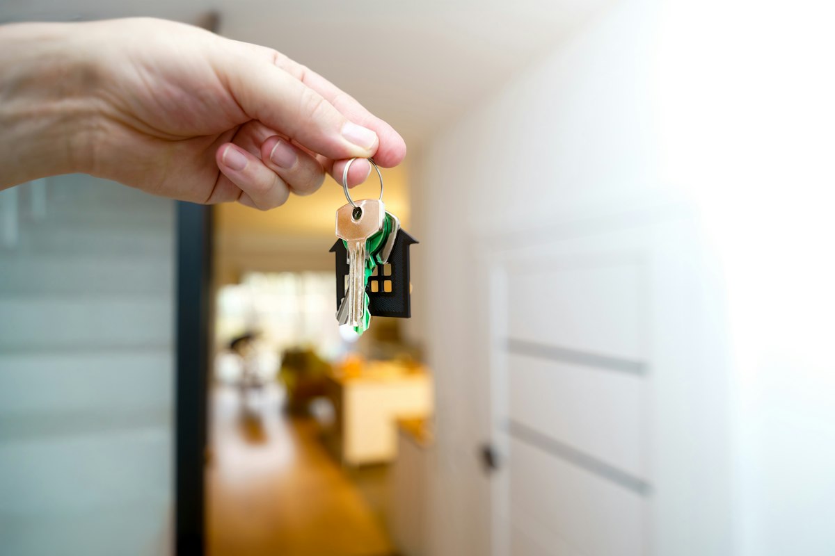 Holding house keys in front of the entrance