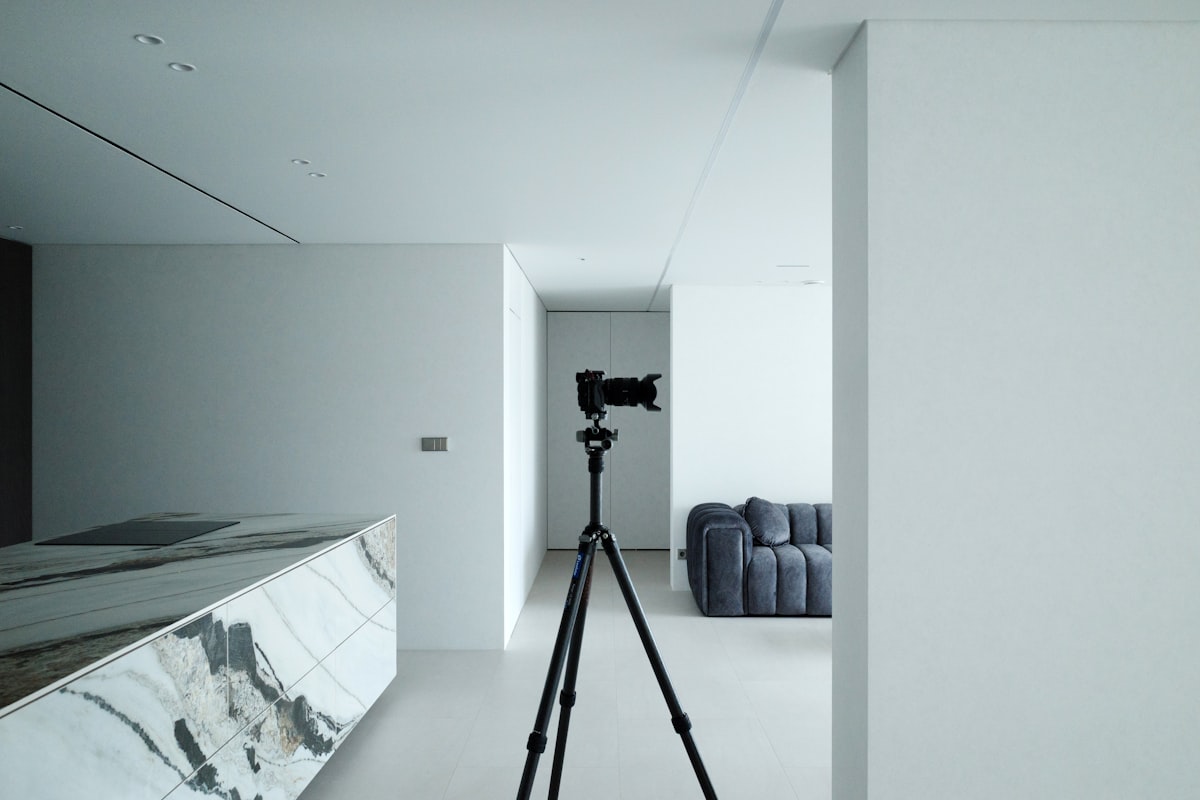 A camera on a tripod in a modern minimalist room.